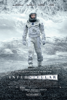 Interstellar movie poster showing a astronaut on a distant planet with a massive wave approaching
